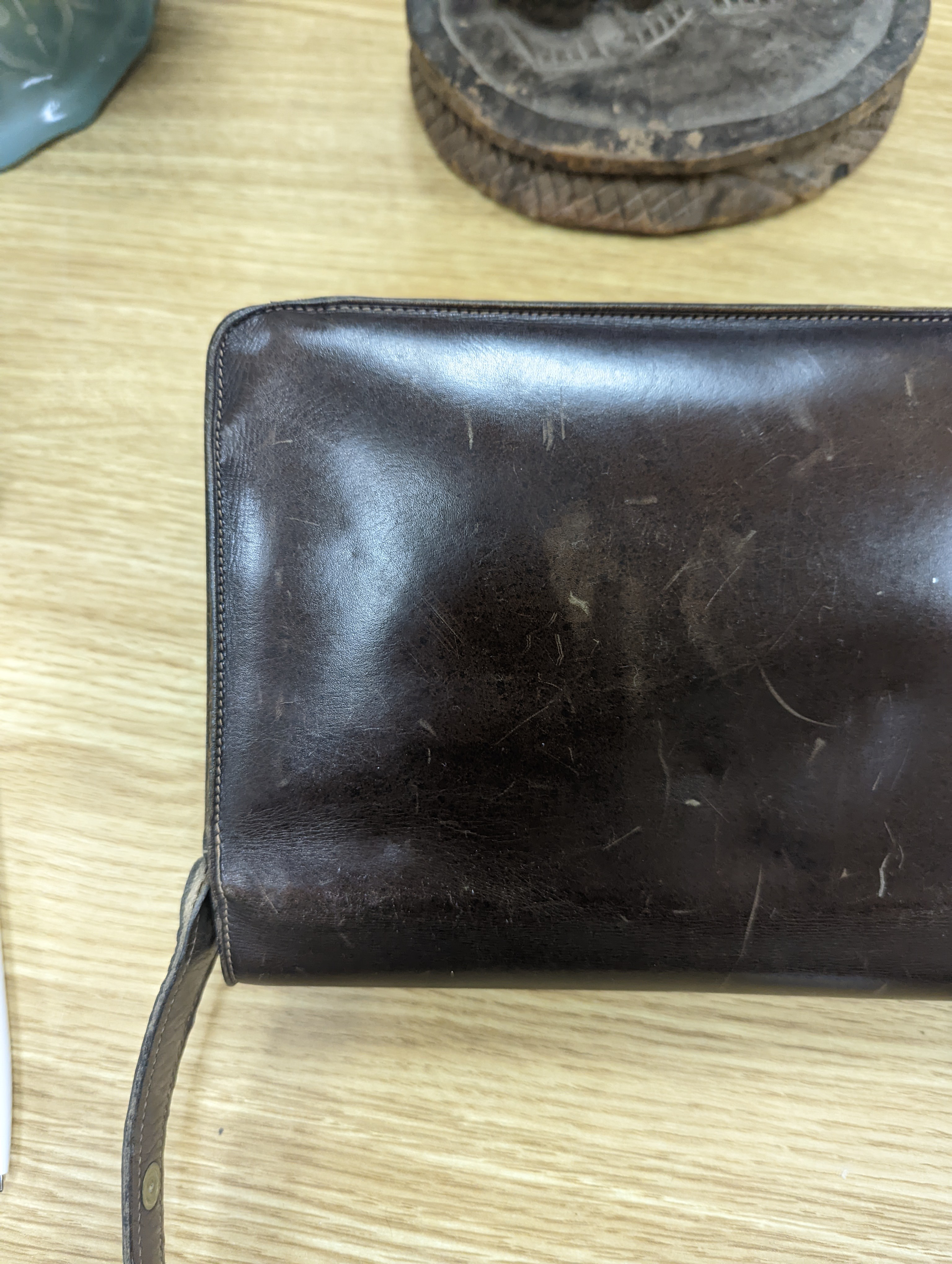 A vintage brown leather handbag stamped 